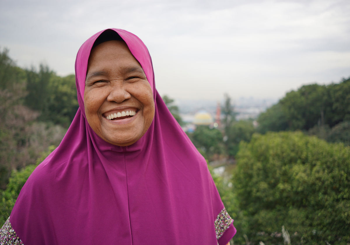 Woman smiling on hillside in Indonesia
