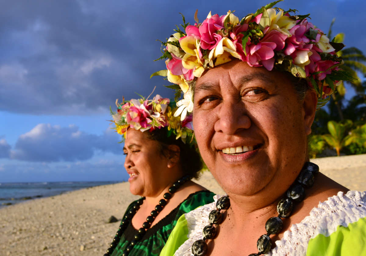 Man and woman on a beach in Tonga wearing traditional clothing