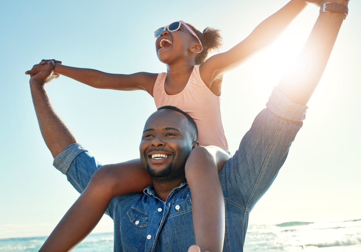 Man holding daughter on his shoulders in Anguilla