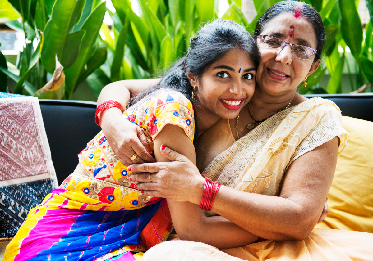 Photo of two women hugging on a couch in Bangladesh