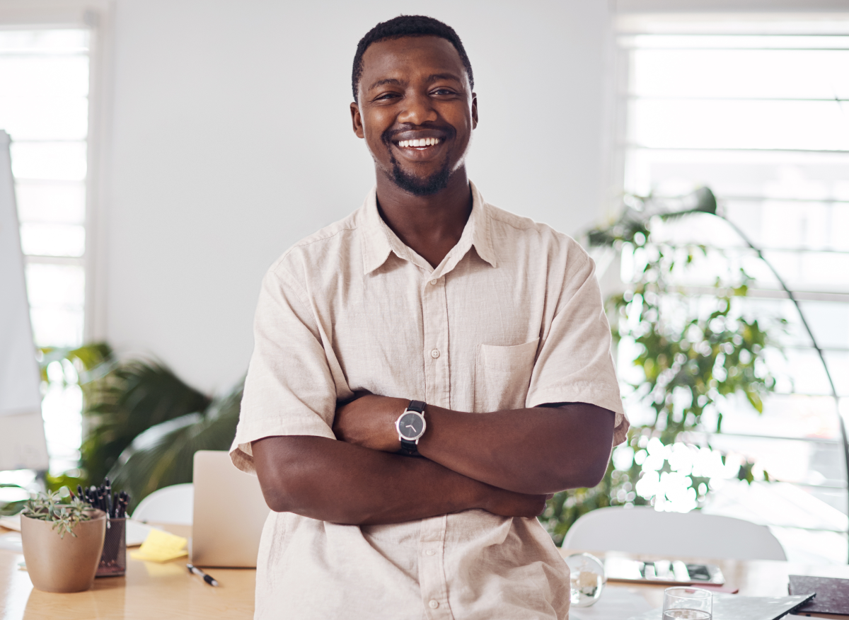 Man smiling in an office building in Suriname