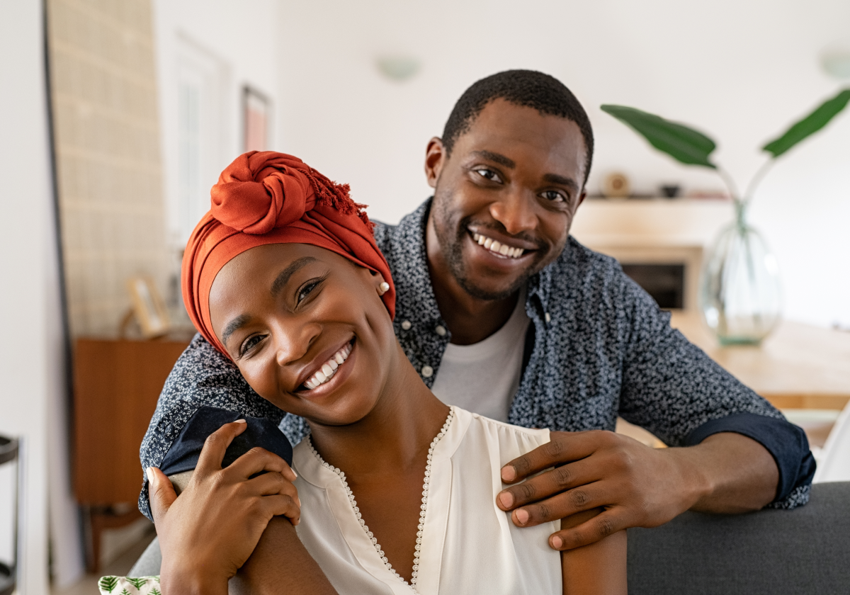 Couple on couch smiling in Zambia