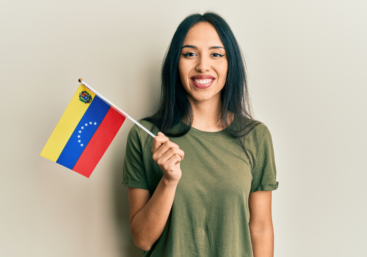 Photo of woman holding the flag of Venezuela