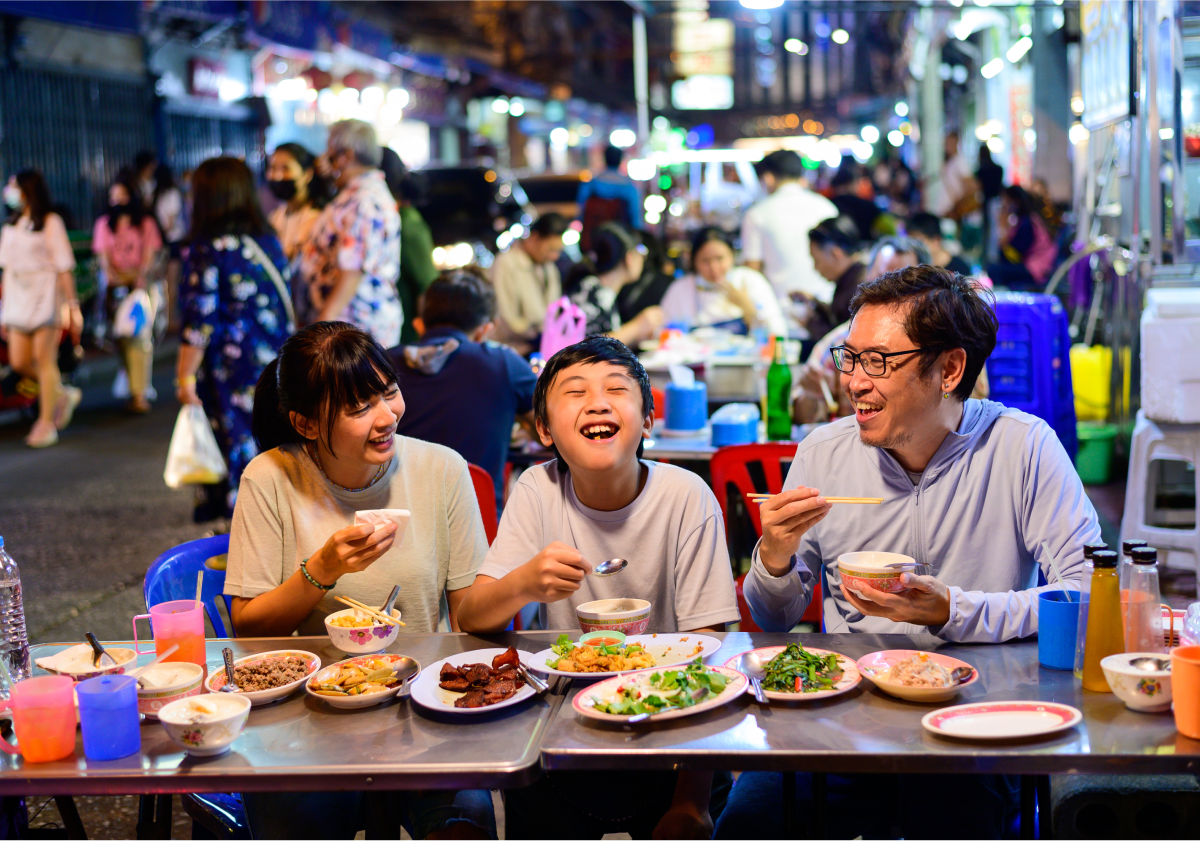 Photo of a family eating outdoors in Thailand