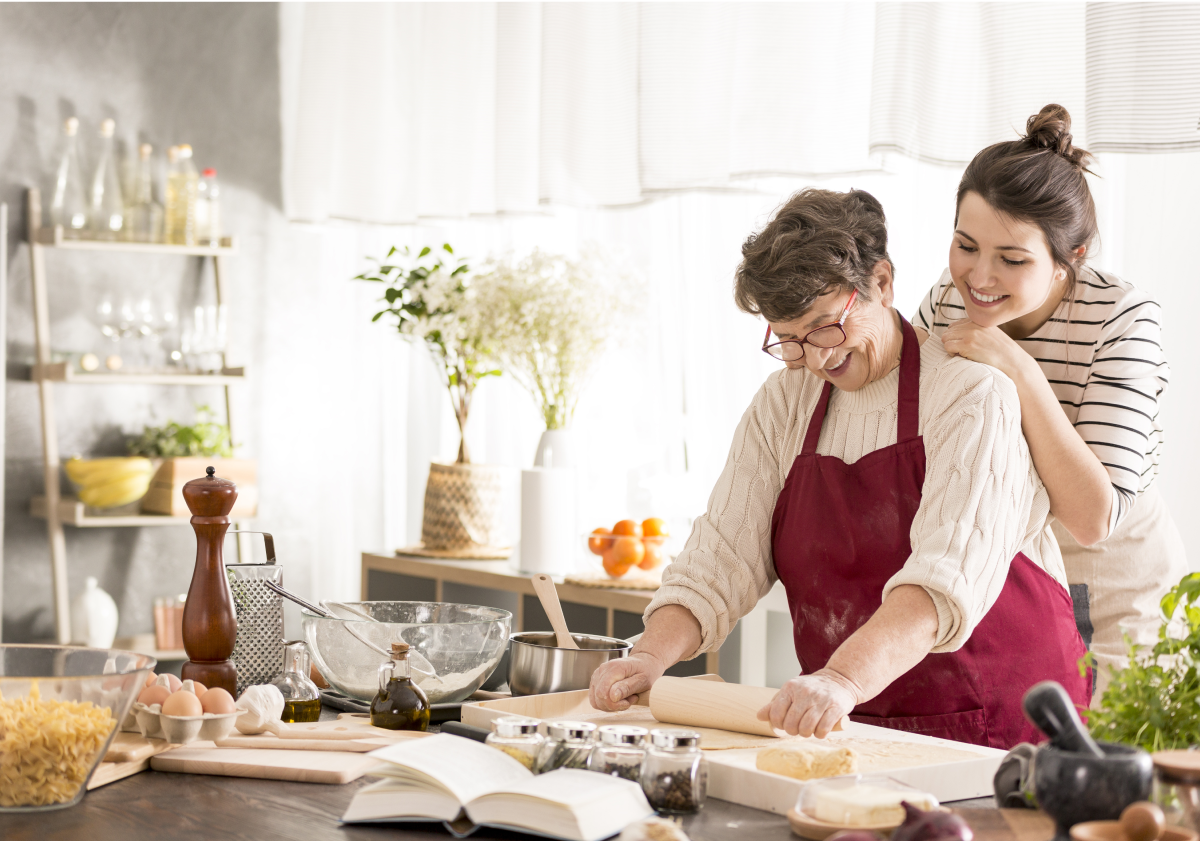 Mother and daughter baking in kitchen in Italy